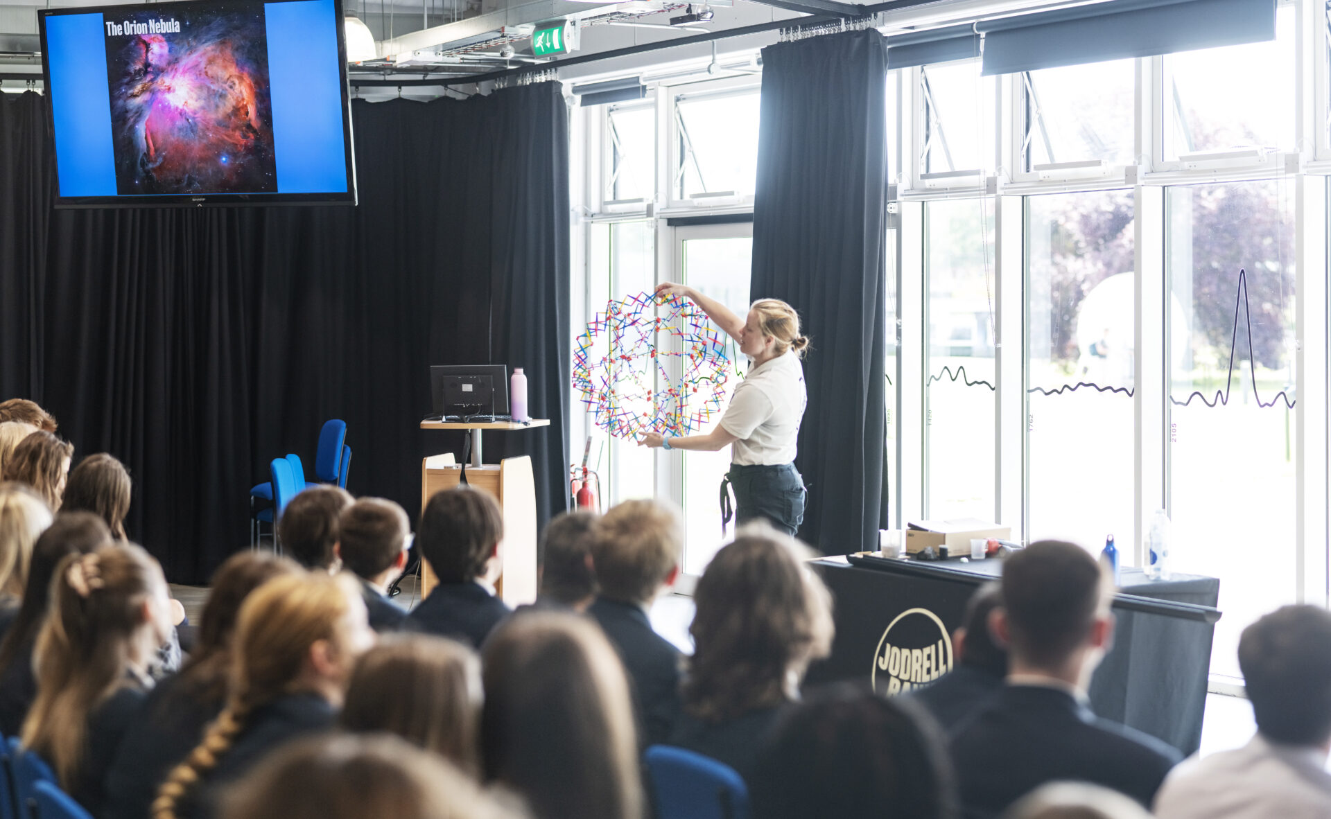 A photo of children engaging with a science show.